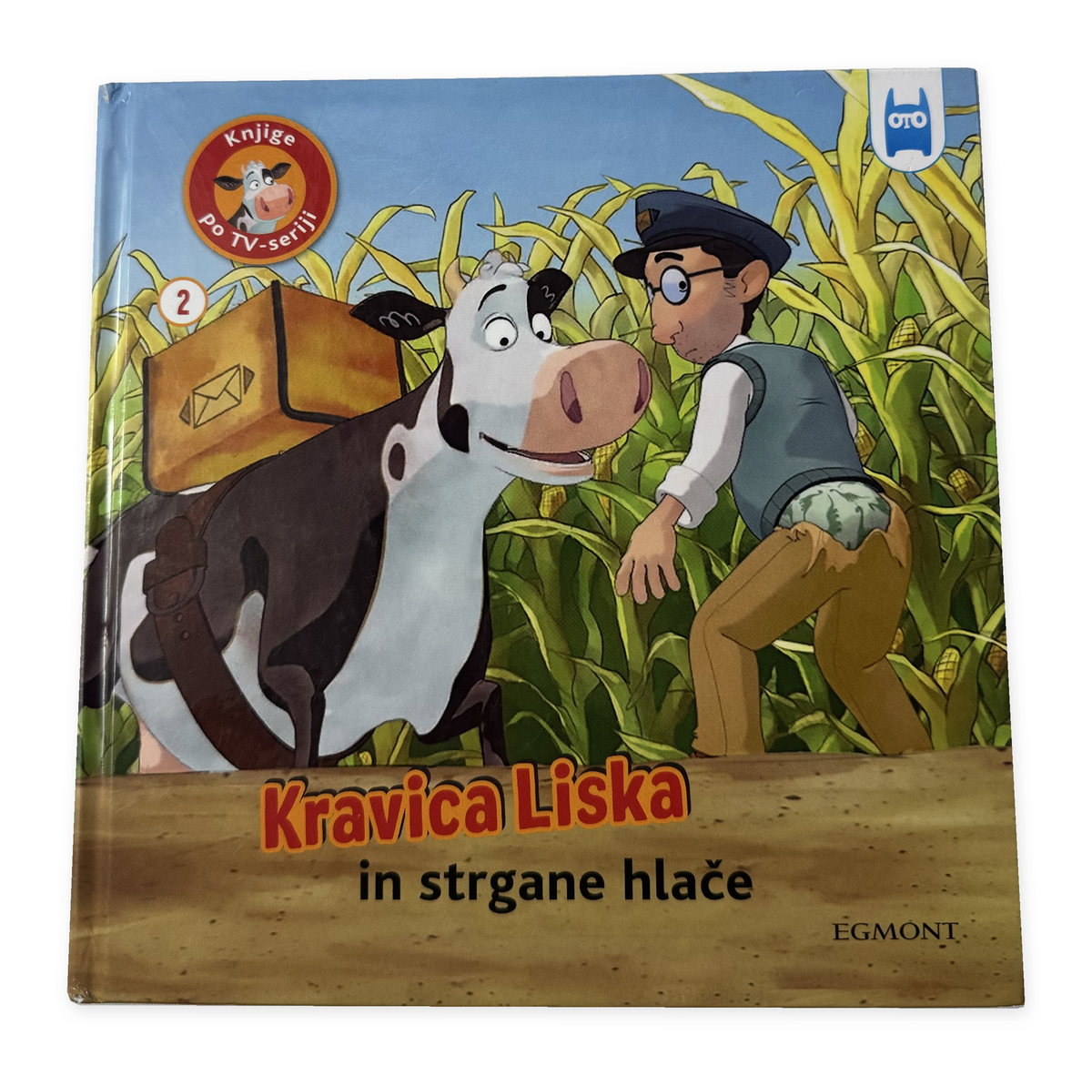 Kravica Liska in strgane hlače – izvirna platnica z ohranjeno obrabo, na belem ozadju
